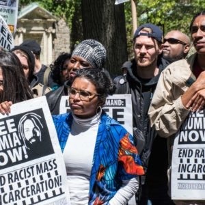 Demonstrators with signs "Free Mumia Now!"